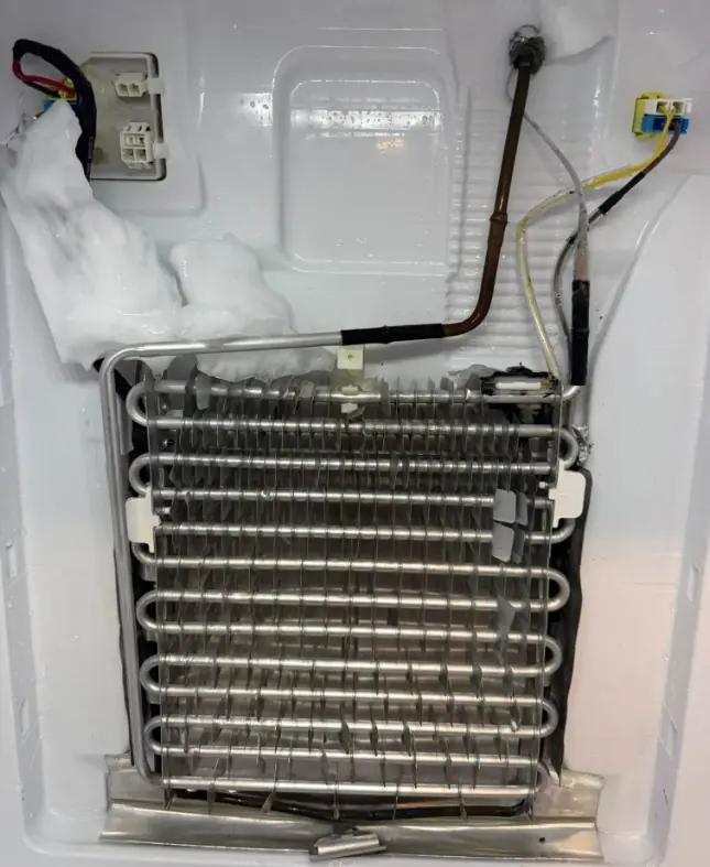 Refrigerator evaporator coil exposed for frost and defrost repair